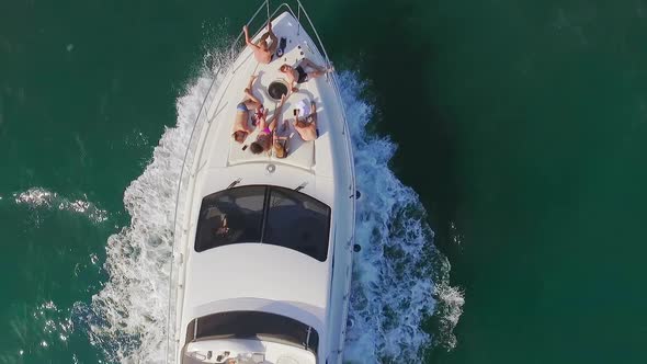 View From Copter Slowmotion Group of Young People Having Fun Sailing on Luxury Yacht Over Open Sea