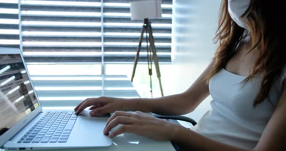 Young Business Woman Typing on Laptop