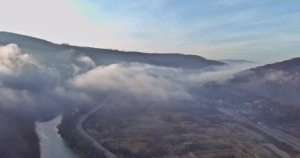 Beautiful Panorama of Aerial View on Autumn Forested Mountain Slope with Morning Fog