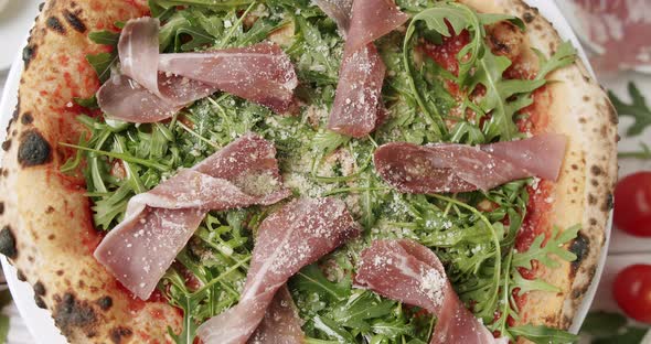 Delicious Pizza with Prosciutto Parma Ham Arugula Salad Rocket with Ingredients