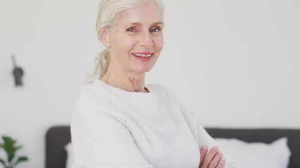 Video of happy caucasian senior woman looking at camera