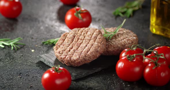 Raw Beef Burger on a Stone Board Rotates. 