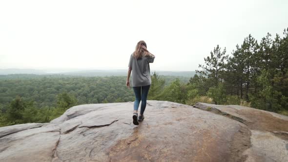 Female hiker walking on mountain slope