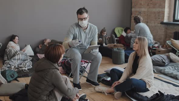 Male Nurse Talking to Refugees