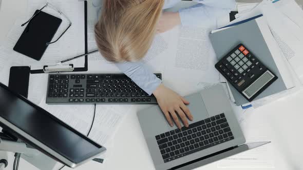 Exhausted Woman Lying on Desktop