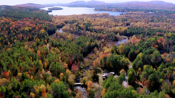 Aerial flythrough of Winding River Through Autumn Trees with Fall Colors in New England