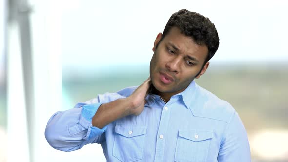 Young Man Suffering From Neck Ache.