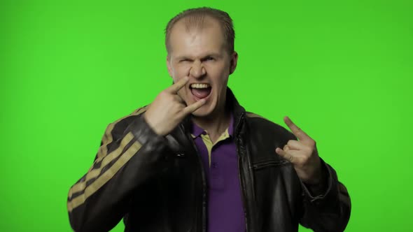 Rocker Man Showing Rock and Roll Sign, Devil Horns Gesture, Looking with Crazy Expression