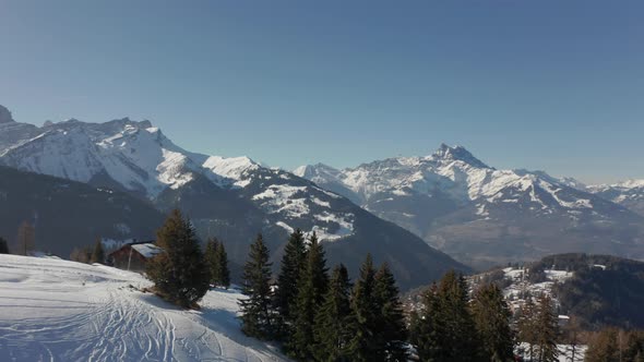 Aerial reveal of beautiful small town in snow covered valley