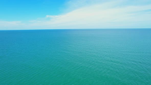 An aerial view over the sea, beautiful sky and clouds