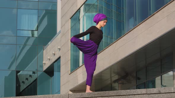 Strong Calm Woman Muslim Islamic Girl in Hijab Barefoot Lady in Purple Pants Stands City Building