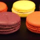 A rows of a colorful macaroons is on the black table - VideoHive Item for Sale