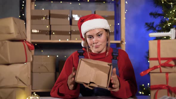 Frustrated Small Business Worker Dressed As Santa Claus Holding Crumpled and Broken Damaged
