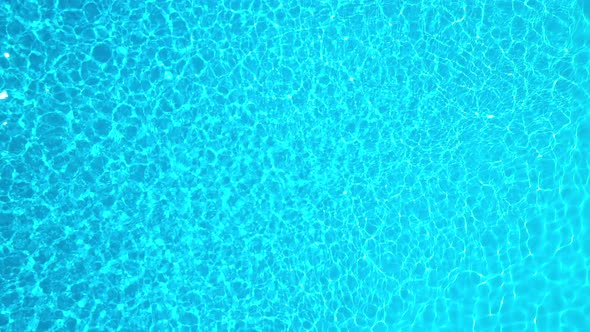 Blue Water in the Swimming Pool with Light Reflections