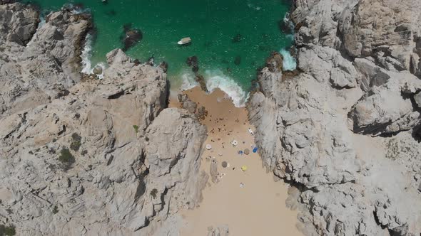 Aerial View of Beach in between Rock Formations