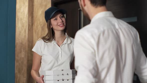 Happy Pizza Delivery Woman Visits Home With Boxes To A Customer, Giving Money To Worker and Showing