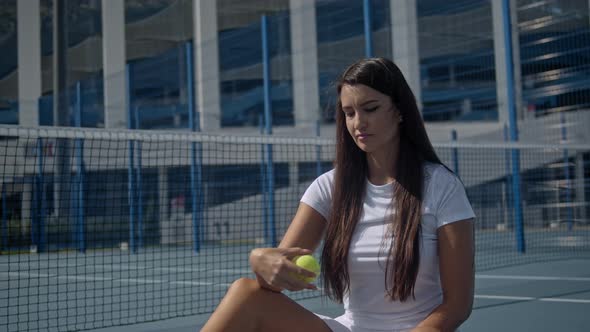 Portrait of Female Tennis Player with Racquet at the Tennis Court Brunette Latin American Woman