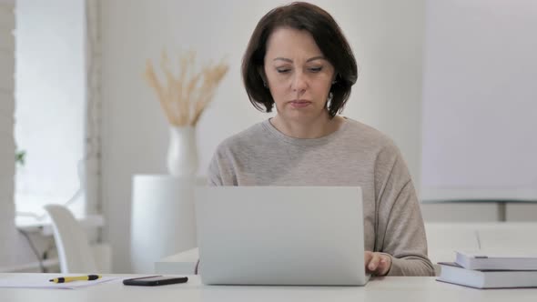 Old Senior Woman Leaving After Completing Work on Laptop