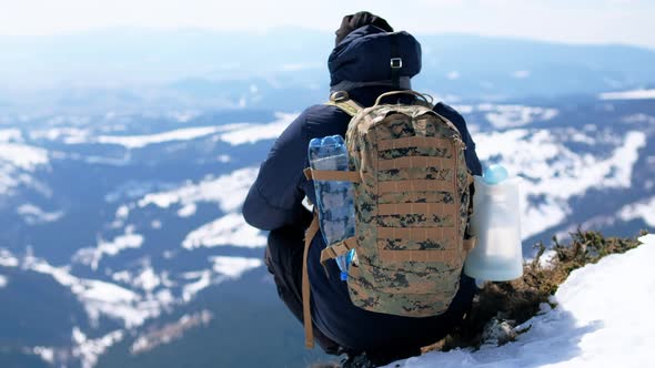 Man is resting and enjoying the beauty of the winter Carpathians at hiking, Romania