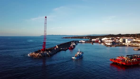 Aerial shot of a Fishing Boat arriving to the port in Madalena, Pico Island. Azores, Portugal.