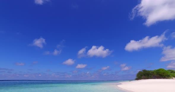 Wide angle drone abstract shot of a sandy white paradise beach and blue ocean background in colorful