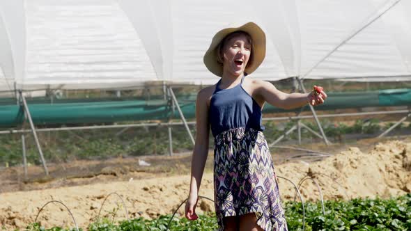 Girl holding strawberry in the farm 4k