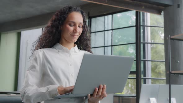 Successful Businesswoman Working in Modern Office Typing on Laptop Remote Communicating with Client