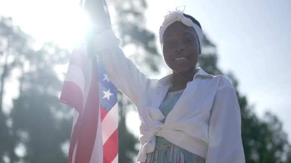 Proud Confident African American Woman with National Flag Smiling Looking at Camera Standing in