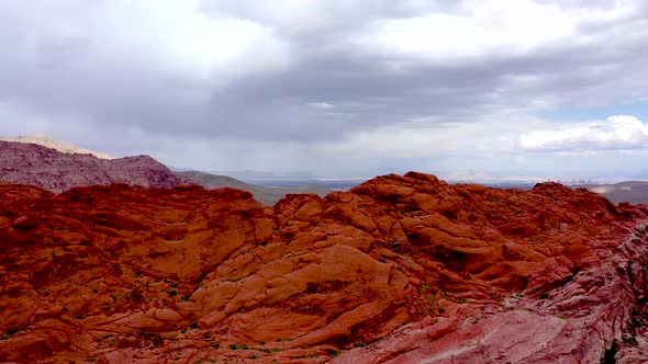 Aerial Drone shot rising up above the Red Rock Canyon Mountains during the daytime in Las Vegas Neva