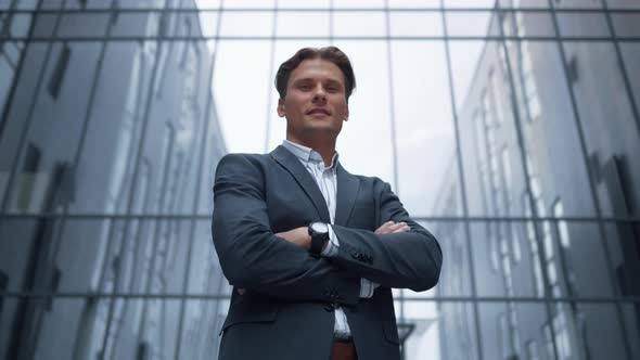 Portrait Smiling Businessman Standing Outside Glass Office Building Alone