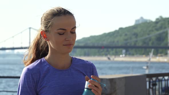 Woman Drinking Water on the Back of View