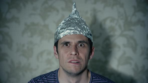Man in a Tin Foil Hat Watching Tv