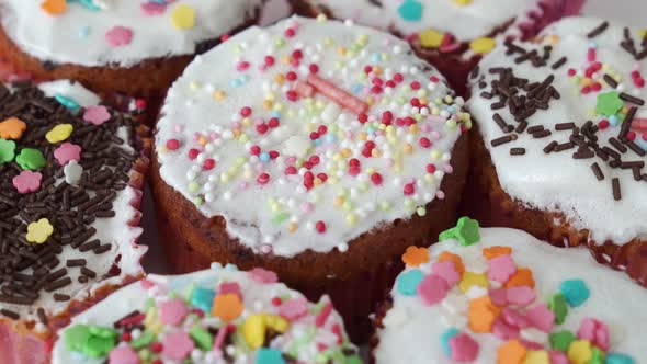 Cupcakes Decorated with Glaze and Sweet Beads Spin