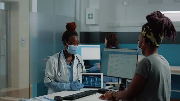 Doctor Holding Tablet with Human Body Analysis for Checkup Visit