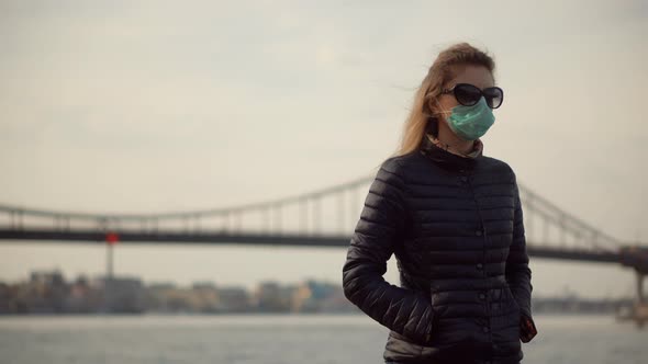 Woman In Mask Protection Epidemic Coronavirus On Nature Outdoors.Sad Girl Walking In Protective Mask