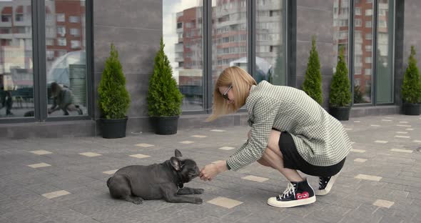 Young Stylish Woman and Cute Bulldog Outdoors