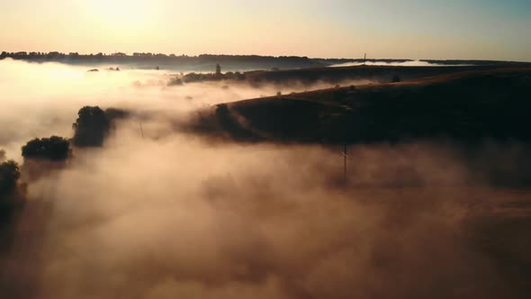 Drove Flying Over Field with Fog