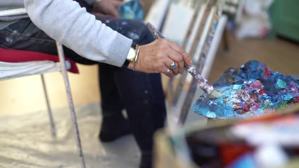 Artist painting in studio, cropped