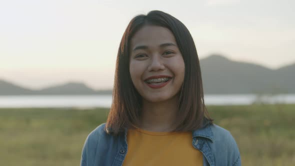 Portrait of beautiful young Asian woman smiling look at camera.