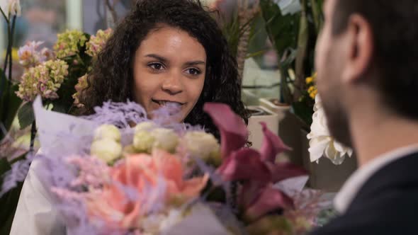 Joyful Florist Giving Flower Composition To Client