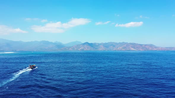 A Stunning Scenery Of A Speed Boat in Indonesia Under The Bright Blue Sky Above - Wide Shot