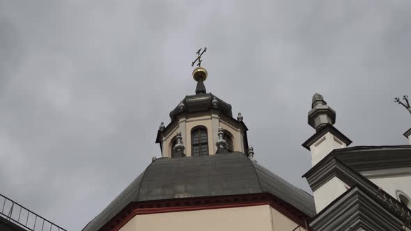 Beautiful Dome with Cross on Old Baroque Catholic Church in Sunlight