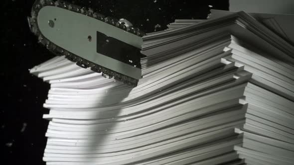 Chainsaw cutting pile of book, Slow Motion