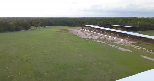 Drone shot of a dairy farm with bales of hay