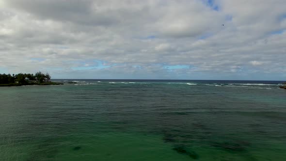 Aerial shot of turquoise Hawaiian waters of Kawela Bay Beech Park near the Turtle Bay Resort.