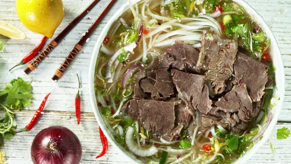 Super Slow Motion Shot of Sliced Beef Falling Into Pho Soup at 1000 Fps