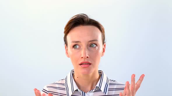 Shocked woman standing against white background