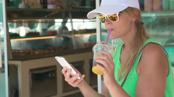 Woman Using Phone in Street on Summer Day