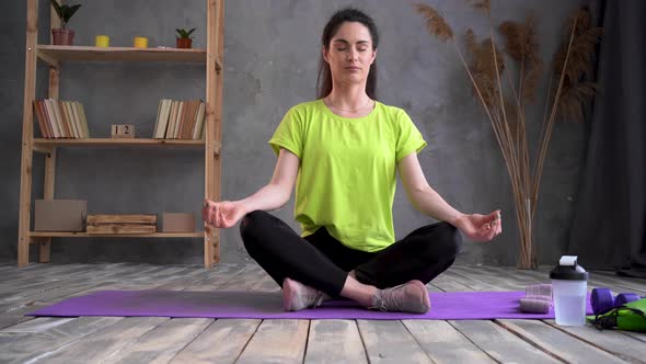 Yoga at Home Young Latin Woman in Lotus Position Sitting on a Sports Mat Relaxing Girl in Sports