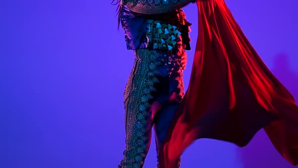 Torero in Blue and Gold Suit or Typical Spanish Bullfighter Isolated Over on a Blue Background